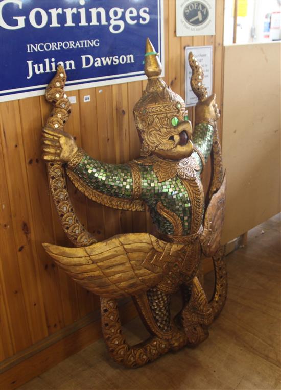 Indonesian gilt and mirrored glass eagle-headed deity figure